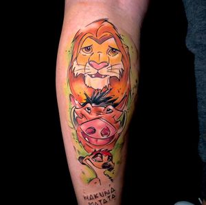 Vibrant new school watercolor design on forearm by Sandro Secchin featuring a lion and Pumbaa from The Lion King.