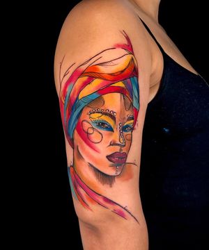Adorn your upper arm with a striking new school rendition of a woman, expertly executed by tattoo artist Sandro Secchin.
