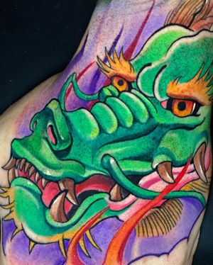 Neo-traditional dragon design on the arm, expertly done by renowned tattoo artist Max Rodriguez.