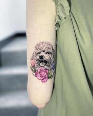 Stunning realism meets illustrative style in this Max Rodriguez masterpiece featuring a dog and flower motif on the upper arm.