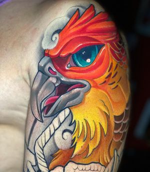 Get a vibrant and dynamic neo-traditional phoenix tattoo on your upper arm by the talented artist Max Rodriguez.