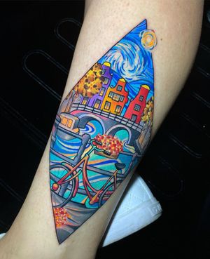 A unique forearm tattoo featuring a bicycle, houses, and a bridge, beautifully illustrated by Max Rodriguez.