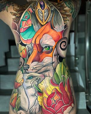 Max Rodriguez's stunning neo-traditional tattoo features a charming rabbit, sly fox, and delicate flower motif on the back.