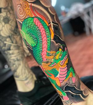 Neo-traditional dragon tattoo on lower leg, beautifully designed by Max Rodriguez.