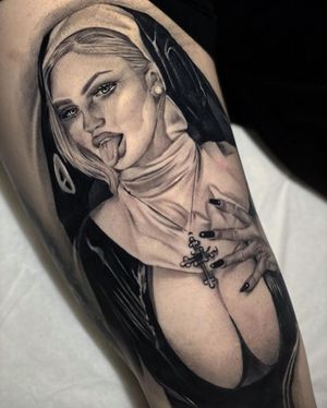Exquisite black and gray portrait of a nun with a cross, by talented artist Max Rodriguez on upper arm.