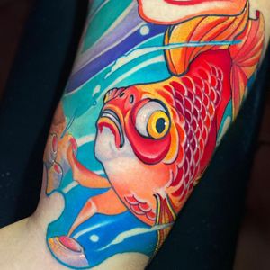 Get a vibrant new school fish tattoo on your arm by the talented artist Max Rodriguez. Stand out with this unique and eye-catching design.