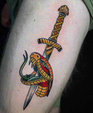 Traditional Japanese style tattoo of a snake and dagger on upper arm by tattoo artist Max Rodriguez.