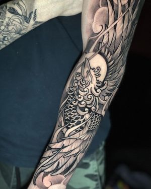 Max Rodriguez's blackwork illustrative design features a striking phoenix feather motif on the forearm.