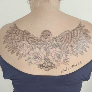 Feminine hawk tattoo with florals 