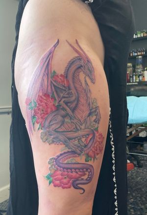 Floral dragon thigh tattoo