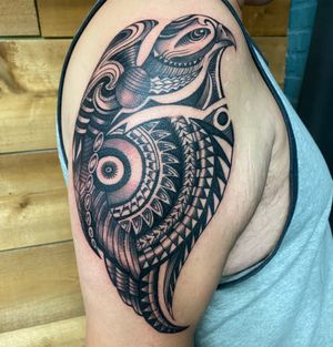 Exquisite blackwork design of a majestic eagle perched on ornamental patterns, expertly inked by Darren Brass.