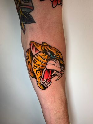 Get a fierce and timeless illustrative tiger tattoo on your forearm in London. A classic design for bold individuals.