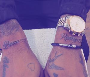Small script of names on the outer wrists