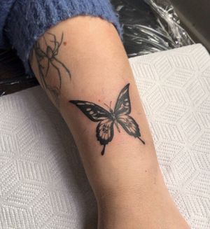Small butterfly just above the wrist.