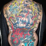 Full back tattoo featuring a kraken, ship and a little moon face blowing a storm around. Most of the tattoo is healed and settled over a year (thanks, global pandemic). We were finally able to finish up coloring the sails after the client and I were both vaccinated. 