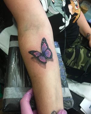 Capture the beauty of nature with this stunning watercolor butterfly tattoo on your forearm by artist Frankie Brown.