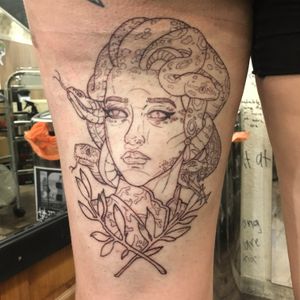 A stunning blackwork tattoo featuring a powerful depiction of Medusa on the upper leg, expertly done by artist Frankie Brown.