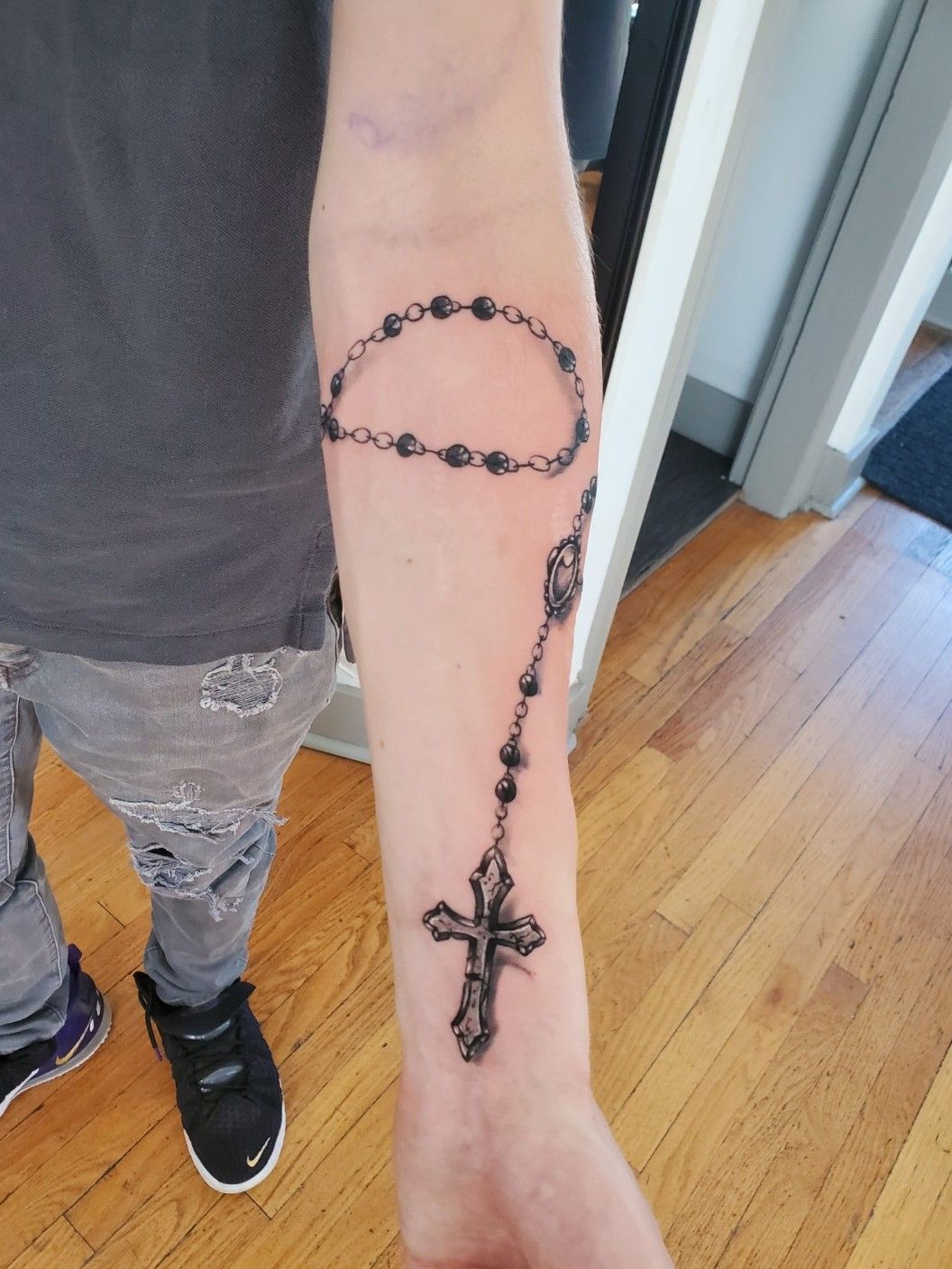 Necklace tattoo on the forearm