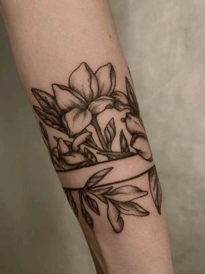 Plumeria flowers on the girl’s forearm