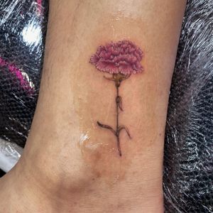 small single needle carnation on the ankle 