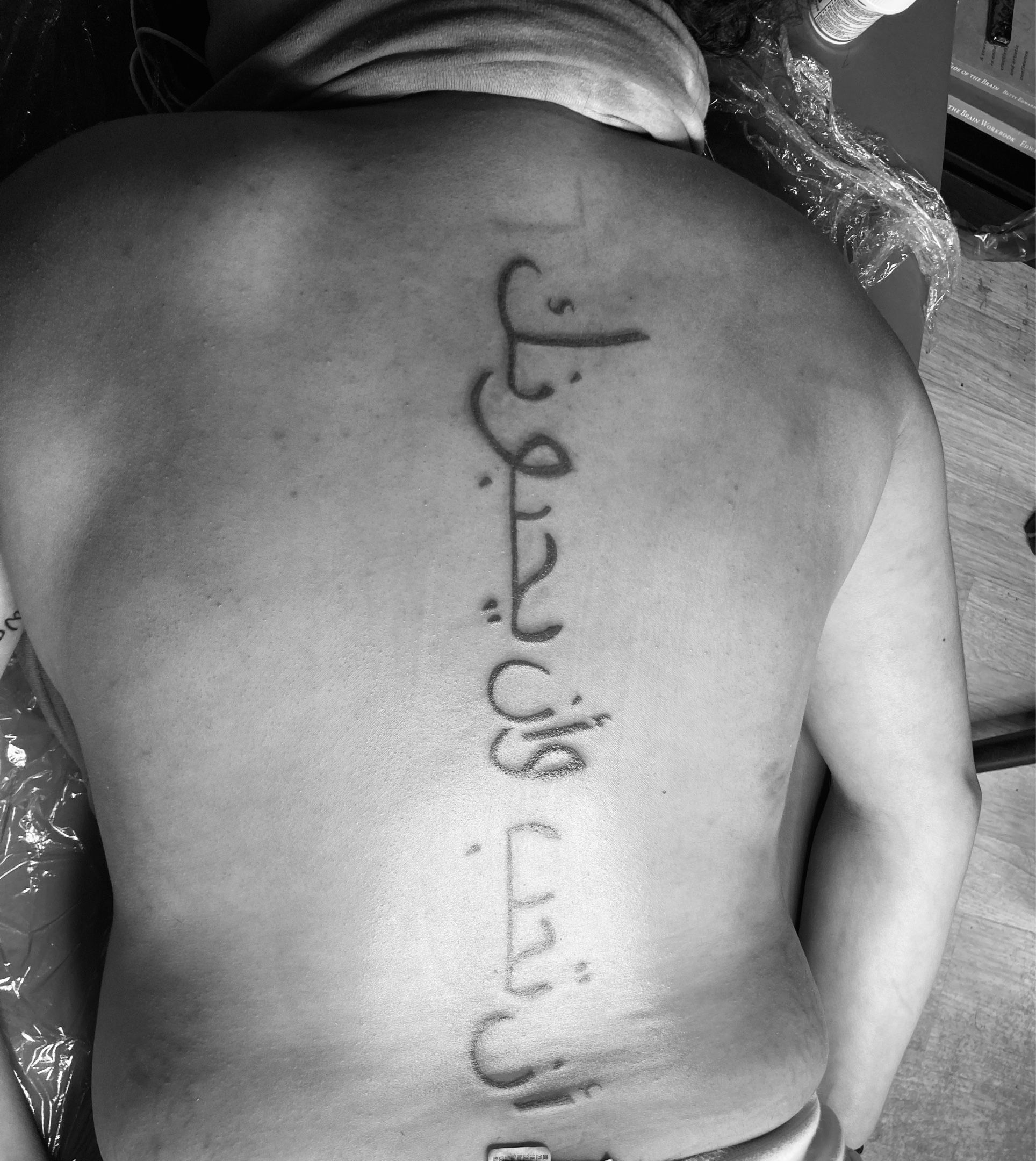 Tattoo uploaded by @ashnicolepainterly • Arabic script down the spine. 