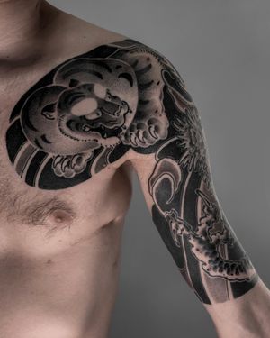 Experience the power of a blackwork Japanese tiger tattoo by FKM TATTOO on your chest. Bold, fierce, and timeless.