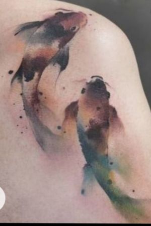 Colorful Koi Fish On Back Of Shoulder