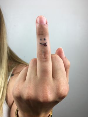 smile tattoo on finger
