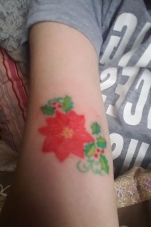 The photo is a little blurry since it was sent to me but this tattoo is healed by a few years. Full color poinsettia 