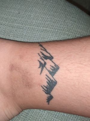 Second tattoo, right ankle mountain