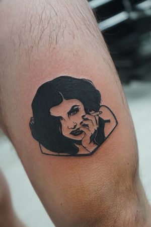 Unique blackwork tattoo by Miss Vampira, featuring a woman with a cigarette on the upper leg.