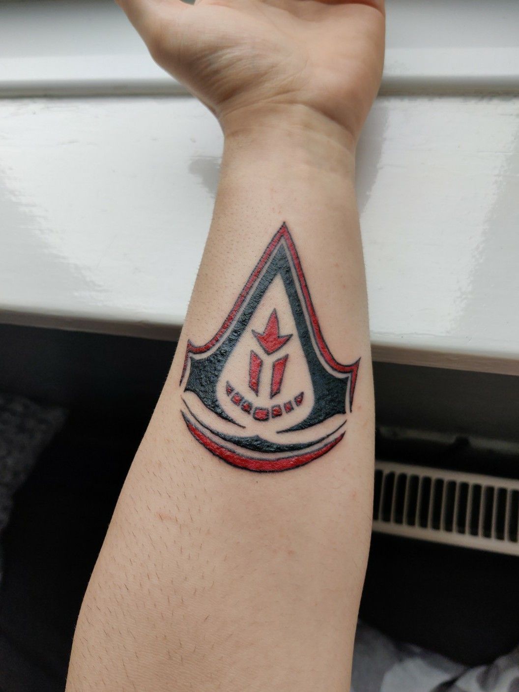 Wanted to share a gaming tattoo I got yesterday The Assassins Creed logo  with added watercolour effect  rgaming