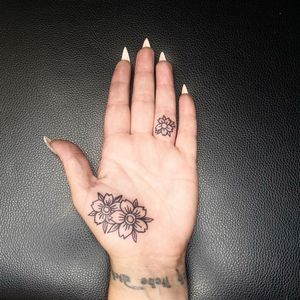 Small flower tattoo on palm 