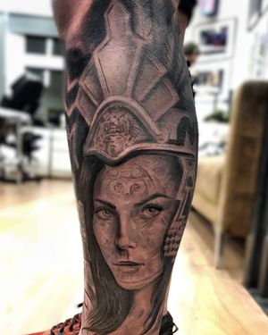 Capture the strength and beauty of a woman in a detailed black and gray tattoo on your lower leg, by Mauro Imperatori.