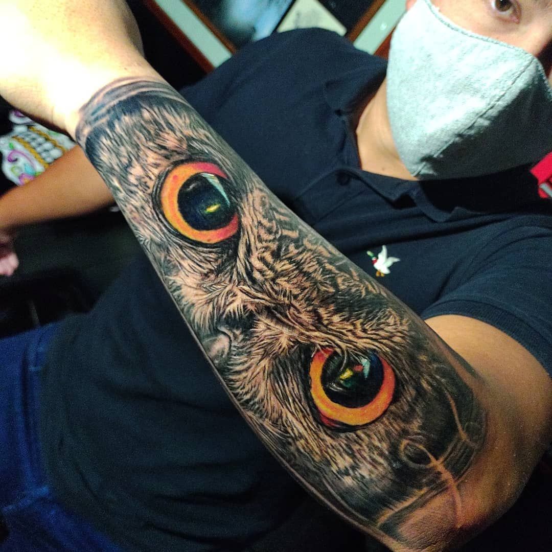 Wolf eyes tattoo on the left forearm