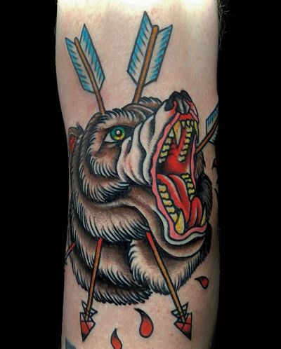 Classic traditional tattoo featuring a bear and arrow, perfect for your arm placement in Los Angeles