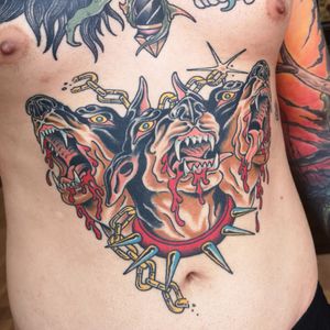 Traditional old school stomach dog cerverus tattoo