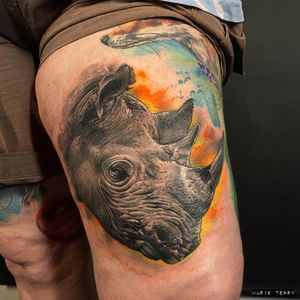 Impressive new school tattoo by Marie Terry featuring a lifelike rhino design on the upper leg.