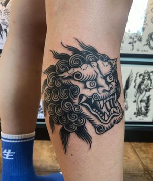 Get a striking and traditional Japanese blackwork foo dog tattoo on your lower leg in the vibrant city of Los Angeles.