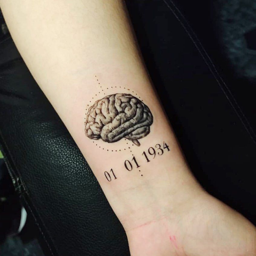 Fine line brain tattoo on the inner arm.