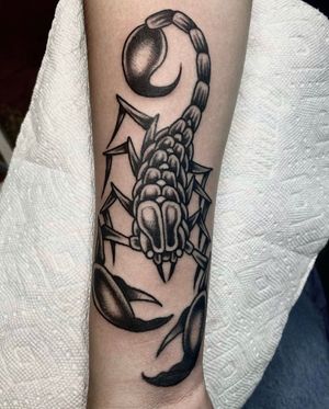 Express your boldness with this traditional blackwork scorpion forearm tattoo in Los Angeles.