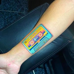Get a bold new_school tape design on your forearm in Los Angeles, capturing your love for music in a unique illustrative style.