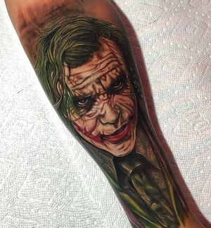 Get a bold and colorful new school Joker tattoo inspired by Heath Ledger's iconic portrayal. Located in Los Angeles, US.