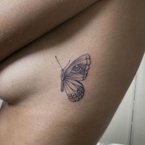Elegantly executed in fine line black and gray style, this butterfly tattoo by Sophie Rose Hunter is a true work of art.