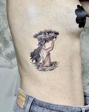 Elegant black and gray fine line tattoo of a woman and flower on ribs by talented artist Sophie Rose Hunter.