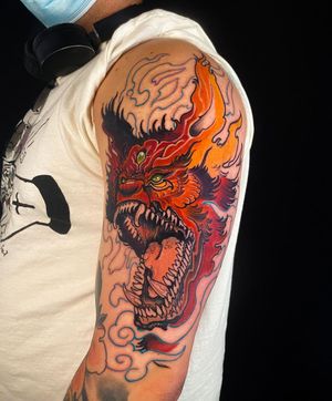 Embrace the fearsome beauty of a Japanese monster inked by Jethro Wood on your upper arm. Let this illustrative design make a bold statement.