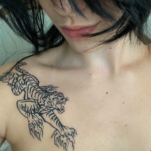Experience the power and grace of a traditional black and gray tiger tattoo by Sophie Rose Hunter on your chest.