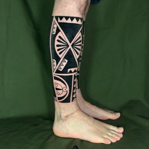 Unique ornamental pattern tattoo on lower leg by Andrea Furci, showcasing stunning blackwork design.