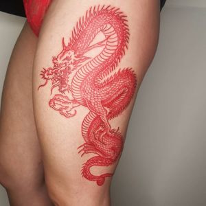 Discover the fierce and mystical beauty of this Japanese dragon tattoo on the upper leg, created by renowned artist Fernando Joergensen.