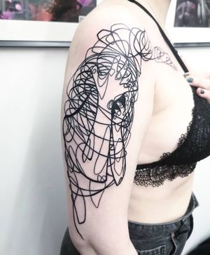 Explore the intricate world of blackwork and fine line surrealism with this upper arm tattoo by Fernando Joergensen.